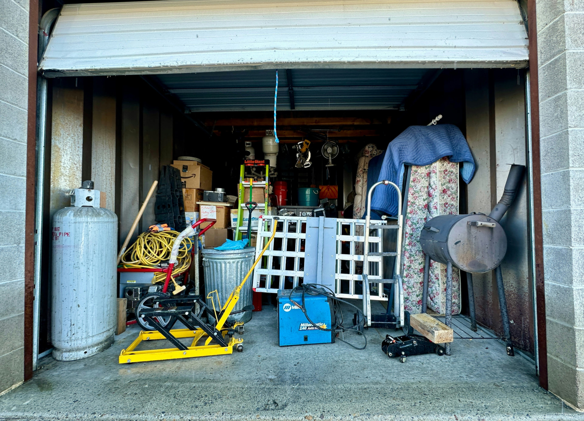 A garage filled with accumulated household belongings and tools